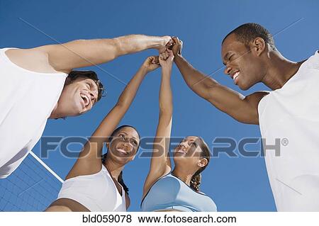Stock Photo - Multi-ethnic friends in huddle. Fotosearch