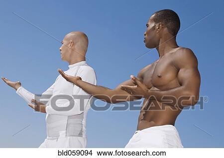 Multi-ethnic men practicing yoga View Large Photo Image Picture - Multi-ethnic men practicing yoga. Fotosearch