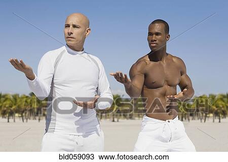 Multi-ethnic men practicing yoga View Large Photo Image Stock Image - Multi-ethnic men practicing yoga. Fotosearch