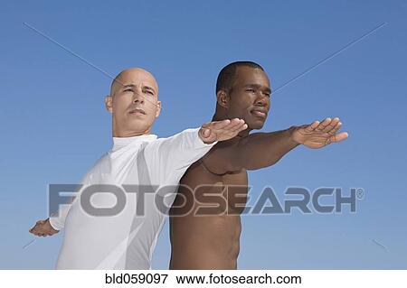 Stock Photo - Multi-ethnic men practicing yoga. Fotosearch