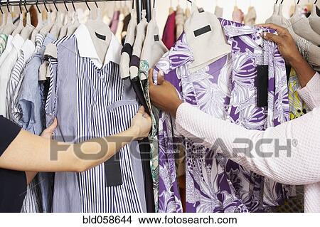 Picture - Multi-ethnic women clothes shopping. Fotosearch