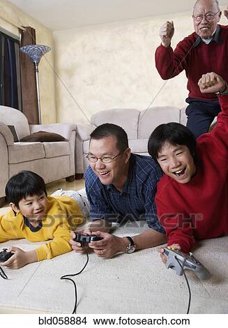 Picture - Multi-generational Asian family playing video games. Fotosearch