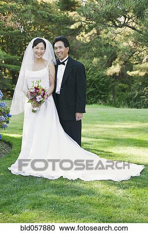 Stock Image - Portrait of Asian newlyweds. Fotosearch