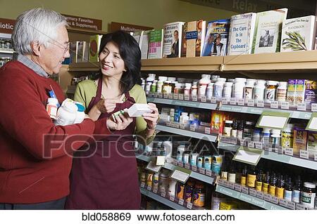 Stock Photo - Senior Asian man shopping for natural medicine. Fotosearch