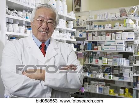 Senior Asian pharmacist with arms crossed View Large Photo Image Stock Image - Senior Asian pharmacist with arms crossed. Fotosearch
