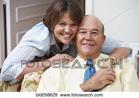 Stock Photo - Senior Hispanic couple hugging. Fotosearch