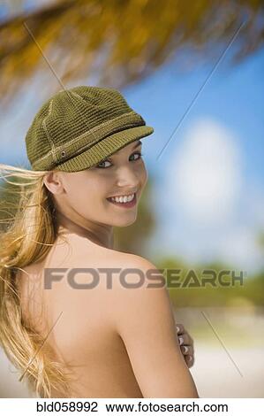 Topless Hispanic woman looking over shoulder View Large Photo Image Stock Image - Topless Hispanic woman looking over shoulder. Fotosearch