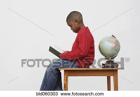 African boy reading book View Large Photo Image Stock Image - African boy reading book. Fotosearch