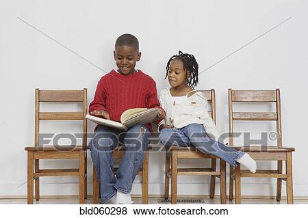 African boy reading to sister View Large Photo Image Stock Photo - African boy reading to sister. Fotosearch