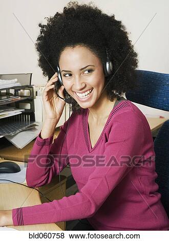 Stock Photo - African businesswoman wearing headset. Fotosearch