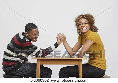 African couple arm wrestling View Large Photo Image Stock Image - African couple arm wrestling. Fotosearch