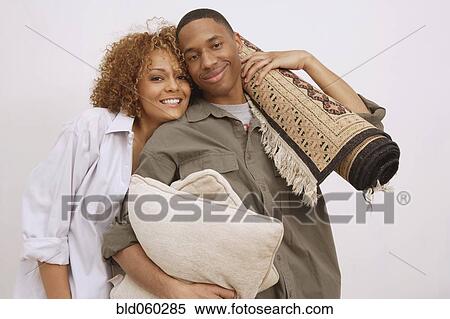 African couple carrying pillows and rug View Large Photo Image Stock Photography - African couple carrying pillows and rug. Fotosearch