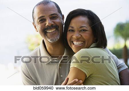 Stock Image - African couple hugging. Fotosearch