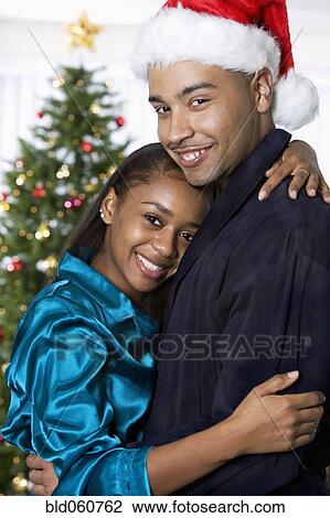 Stock Image - African couple hugging. Fotosearch