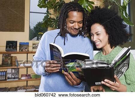 Stock Image - African couple reading books. Fotosearch
