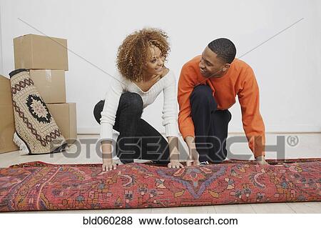 African couple rolling rug View Large Photo Image Stock Photo - African couple rolling rug. Fotosearch