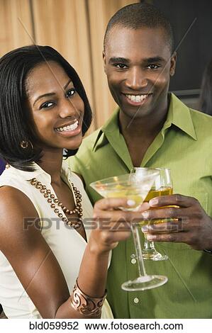 African couple toasting with cocktails View Large Photo Image Stock Image - African couple toasting with cocktails. Fotosearch