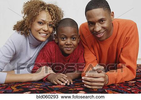 African family laying on rug View Large Photo Image Stock Image - African family laying on rug. Fotosearch