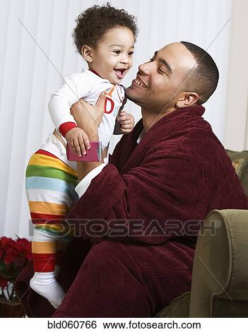 African father smiling at baby View Large Photo Image Stock Photograph - African father smiling at baby. Fotosearch