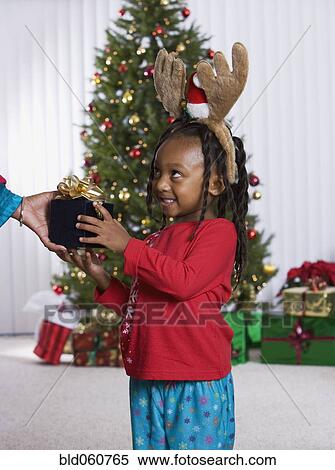 African girl accepting Christmas gift View Large Photo Image Stock Photography - African girl accepting Christmas gift. Fotosearch