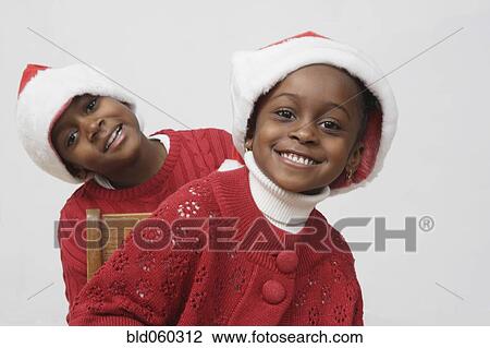 African siblings wearing Santa Claus hats View Large Photo Image Stock Image - African siblings wearing Santa Claus hats. Fotosearch