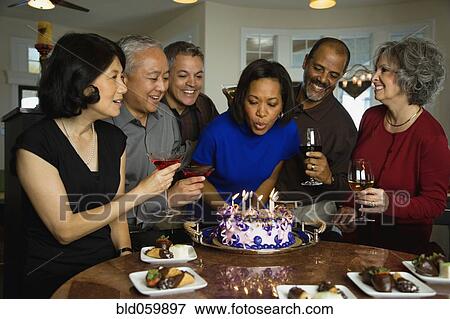 African woman celebrating birthday with multi-ethnic friends View Large Photo Image Stock Photo - African woman celebrating birthday with multi-ethnic friends. Fotosearch