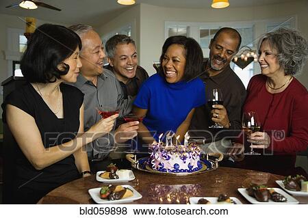African woman celebrating birthday with multi-ethnic friends View Large Photo Image Stock Photo - African woman celebrating birthday with multi-ethnic friends. Fotosearch