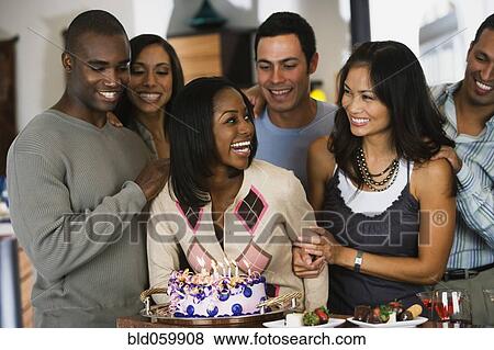 African woman celebrating birthday with multi-ethnic friends View Large Photo Image Stock Photo - African woman celebrating birthday with multi-ethnic friends. Fotosearch
