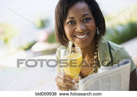 African woman drinking orange juice View Large Photo Image Stock Photo - African woman drinking orange juice. Fotosearch