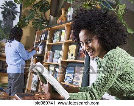 African woman holding book View Large Photo Image Stock Image - African woman holding book. Fotosearch