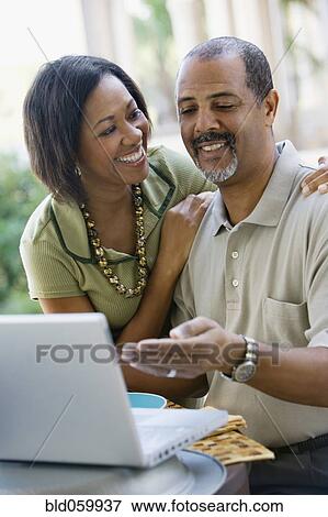 Stock Photo - African woman smiling at husband. Fotosearch