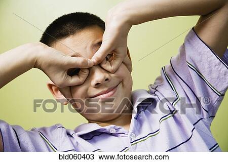 Stock Image - Asian boy being silly. Fotosearch