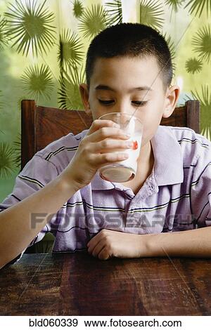 Stock Photo - Asian boy drinking milk. Fotosearch