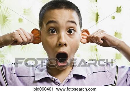 Stock Image - Asian boy pulling on ears. Fotosearch