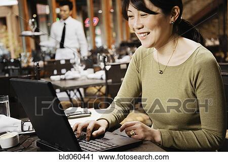 Asian businesswoman typing on laptop View Large Photo Image Stock Image - Asian businesswoman typing on laptop. Fotosearch