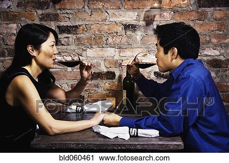 Stock Image - Asian couple drinking wine. Fotosearch