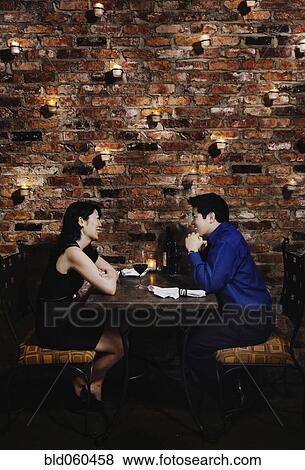 Stock Photo - Asian couple eating at restaurant. Fotosearch