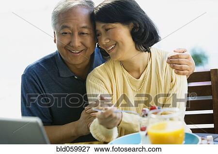 Stock Photo - Asian couple hugging. Fotosearch