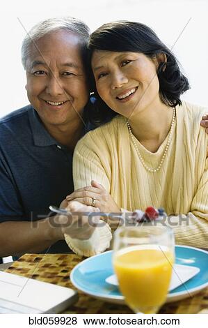 Asian couple hugging View Large Photo Image Stock Photo - Asian couple hugging. Fotosearch
