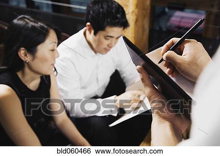 Stock Photograph - Asian couple ordering food at restaurant. Fotosearch