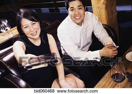 Asian couple paying restaurant bill View Large Photo Image Stock Photo - Asian couple paying restaurant bill. Fotosearch