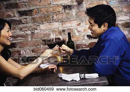 Stock Photo - Asian couple toasting with wine. Fotosearch
