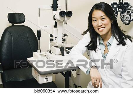 Asian female optometrist in office View Large Photo Image Picture - Asian female optometrist in office. Fotosearch