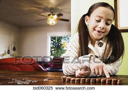 Stock Photography - Asian girl counting coins. Fotosearch