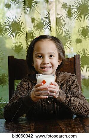 Stock Image - Asian girl drinking milk. Fotosearch