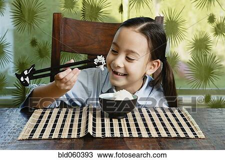 Asian girl eating bowl of rice View Large Photo Image Stock Image - Asian girl eating bowl of rice. Fotosearch