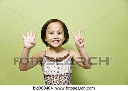 Picture - Asian girl holding up six fingers. Fotosearch