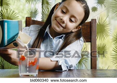 Asian girl pouring glass of milk View Large Photo Image Stock Image - Asian girl pouring glass of milk. Fotosearch