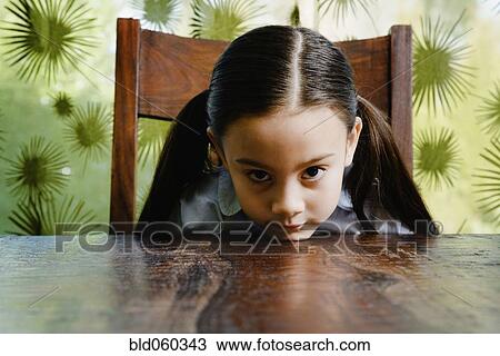 Asian girl resting chin on table View Large Photo Image Stock Image - Asian girl resting chin on table. Fotosearch