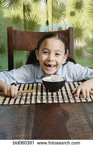 Asian girl with bowl of rice View Large Photo Image Stock Image - Asian girl with bowl of rice. Fotosearch